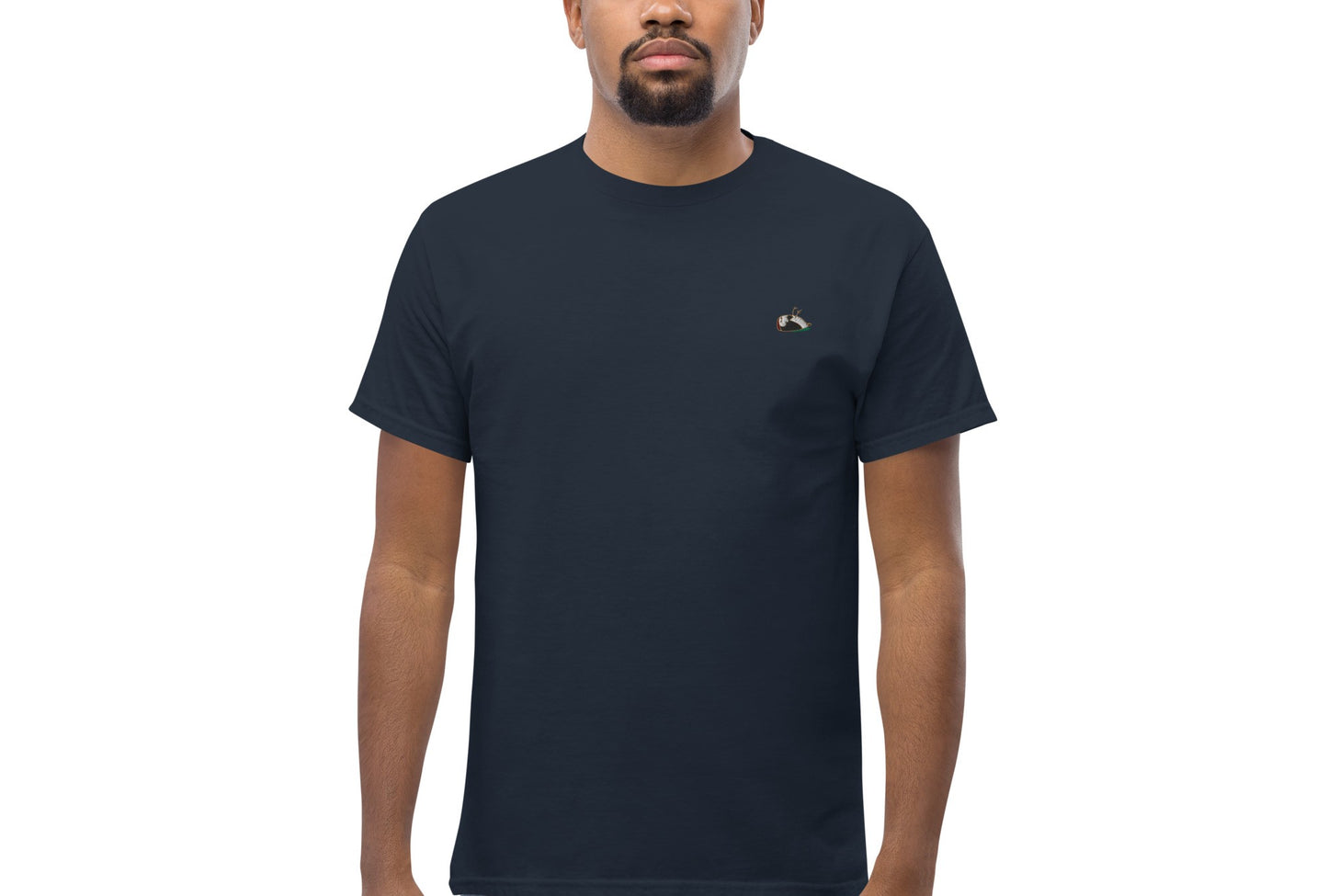 Image of a man wearing the Sharp t-shirt. The colour of the t-shirt is navy,sparrow embroidered on the left side of the t-shirt.