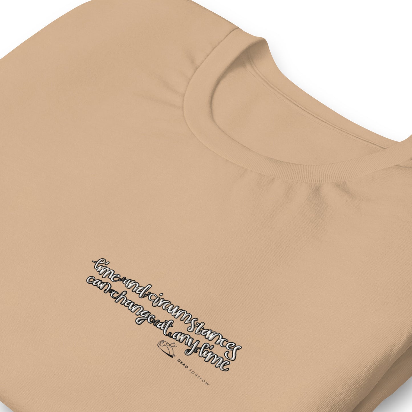 Image of an eco-friendly Desert Dust t-shirt for men. In the image, the t-shirt is folded and has a quote printed on the left side. The quote reads "time and circumstances can change at any time". The product name Strong.