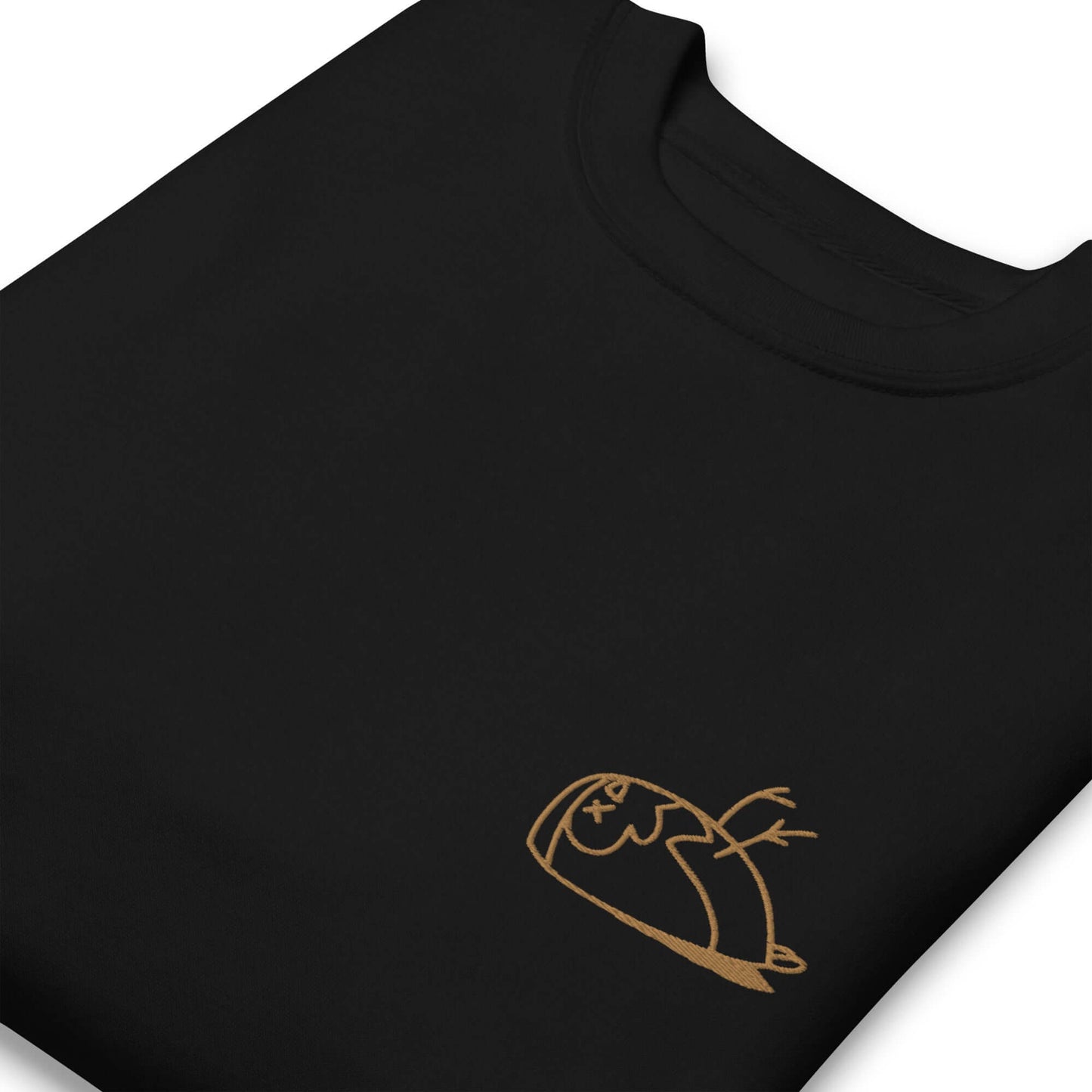 Close-up of a DEADsparrow sweatshirt for children. The sweatshirt is black, soft and folded. The sparrow is embroidered on the left side of the sweatshirt with gold coloured thread. Product name Valuable.