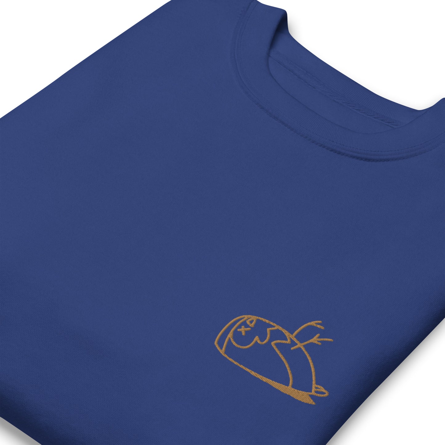 Close-up of a DEADsparrow sweatshirt for children. The sweatshirt is royal, soft and folded. The sparrow is embroidered on the left side of the sweatshirt with gold coloured thread. Product name Valuable.