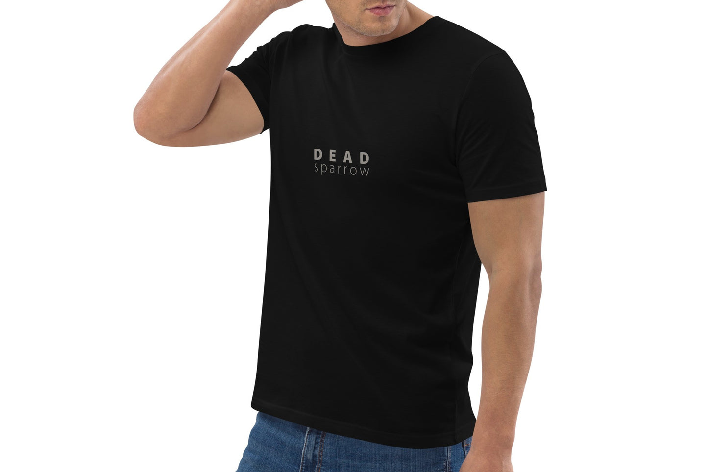 Close-up of a man wearing a black t-shirt, item name Smile. The t-shirt has a print centred on the DEAD sparrow (logo).