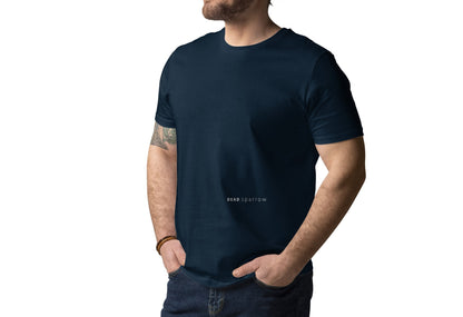 Image of a man wearing an organic French navy t-shirt. Printed text on the left side of the t-shirt, below the chest. The text reads DEAD sparrow (logo). Product name Driven.