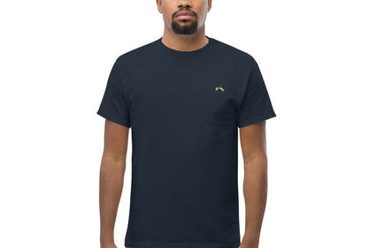 Image of a man wearing the Sharp t-shirt. The colour of the t-shirt is navy,sparrow embroidered on the left side of the t-shirt. 