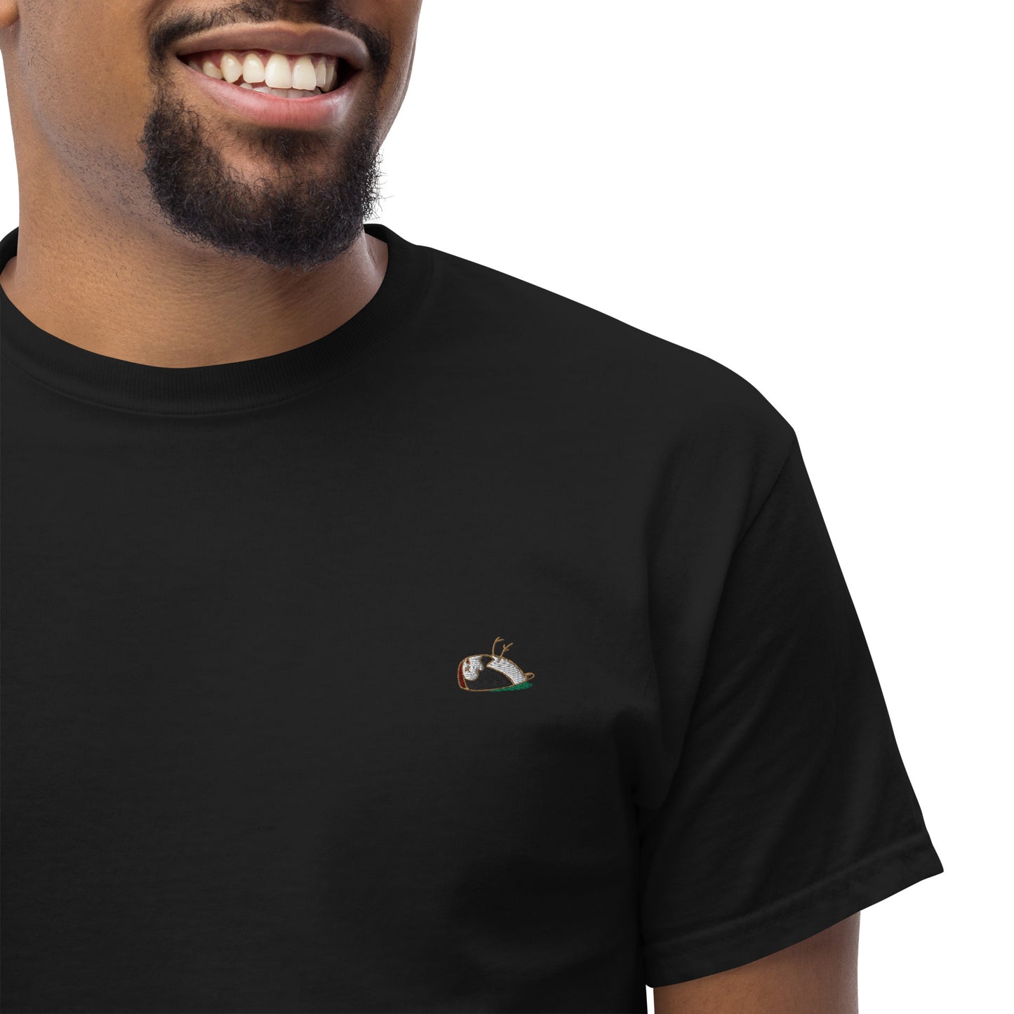 Close up, man wearing (Sharp) t-shirt. The colour of the t-shirt is black, multi-coloured sparrow embroidered on the left side of the t-shirt.