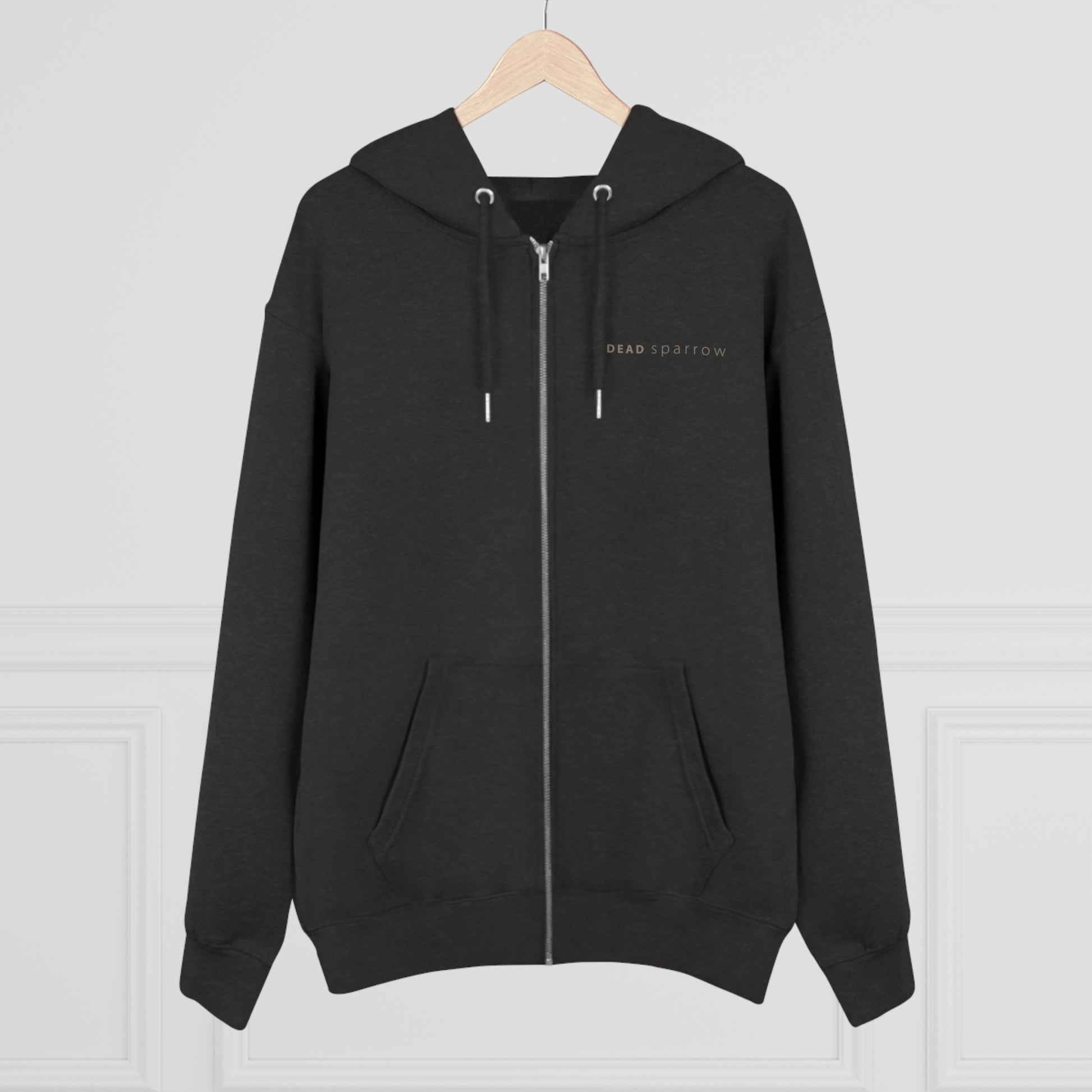 Image of a dark heather grey zip-up hoodie, item name Observent. The hoodie has a print on the left side, 'DEAD sparrow' (logo).