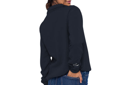 Close-up of a woman wearing a navy zip up sweatshirt. DEADsparrow logo embroidered on the left side in white. Product name Outstandning. Outstanding has soft fleece frabric inside and matching color zipper.