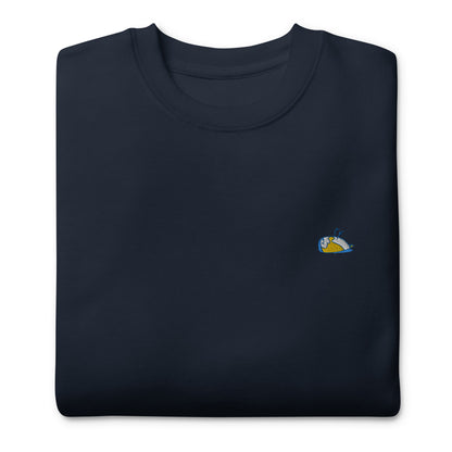 Image shows a folded sweater, Thoughtful. Color: Navy with a multicoloured sparrow embroidered on the left side of the t-shirt. The picture shows a folded sweater, Thoughtful.