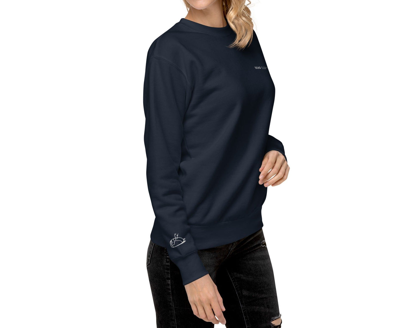 Right front view of a woman wearing a navy blue sweatshirt. The text "Deadsparrow" embroidered on the left side of the sweatshirt and sparrow lying on its back, embroidered on the right sleeve in white thread. Product name Brave.