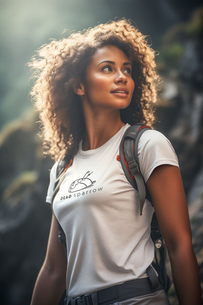 Image of a women looking up wearing backpack and a white t-shirt for women. DEADsparrow logo printed across the chest of the t-shirt. Product name Powerful.