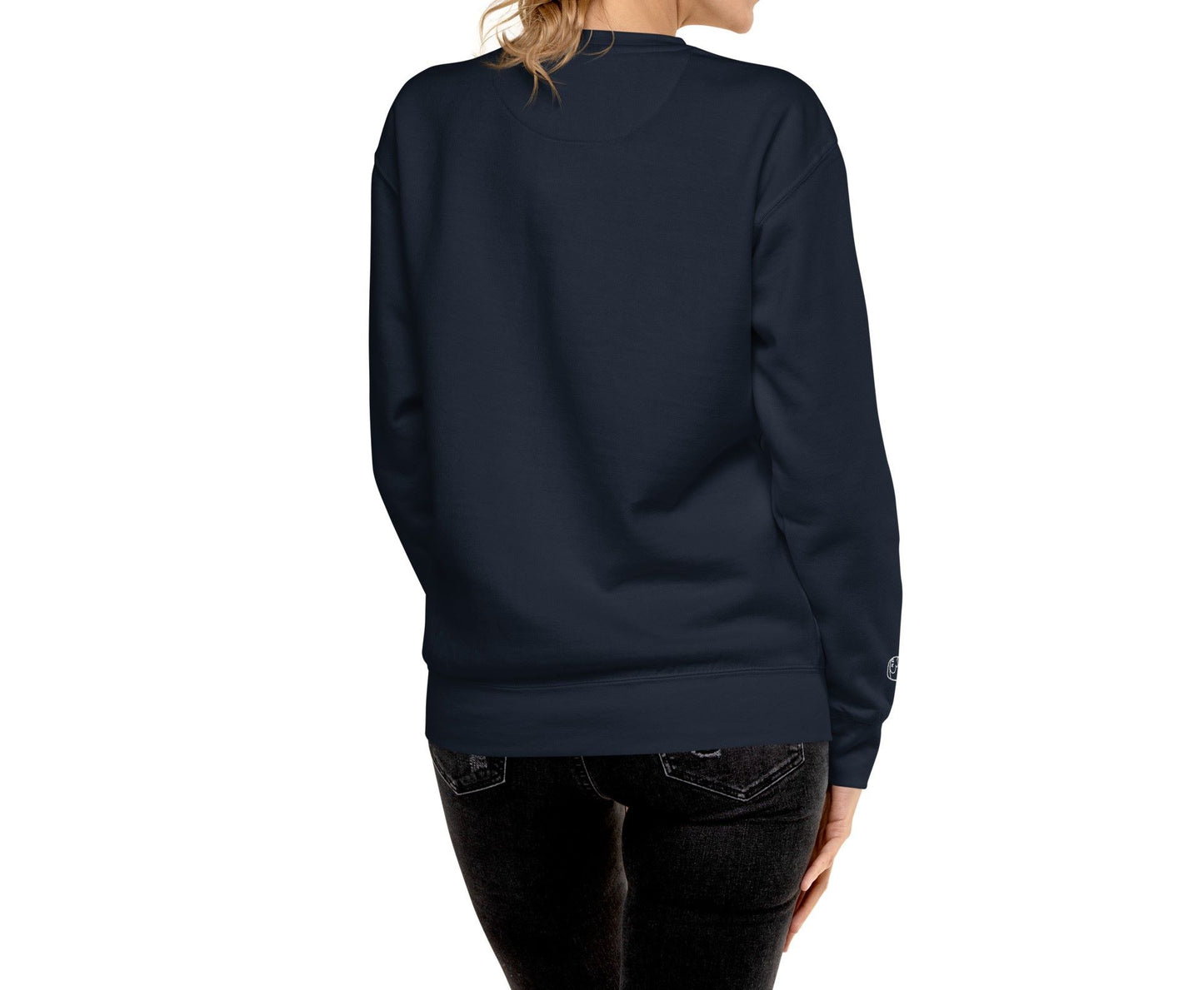 Right front view of a woman wearing a navy blue sweatshirt. The text "Deadsparrow" embroidered on the left side of the sweatshirt and sparrow lying on its back, embroidered on the right sleeve in white thread. Product name Brave.