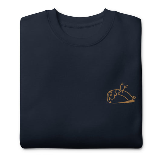 Close-up of a DEADsparrow sweatshirt for children. The sweatshirt is navy, soft and folded. The sparrow is embroidered on the left side of the sweatshirt with gold coloured thread. Product name Valuable.