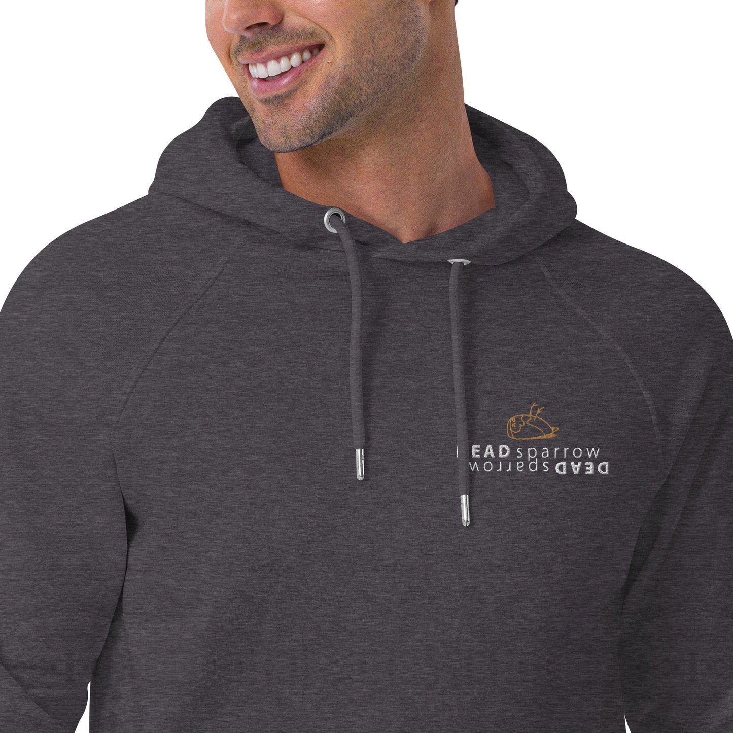 Close-up of a man wearing charcoal melange hoodie, product name gratitude. The hoodie has a print on the left on the DEAD sparrow (logo).