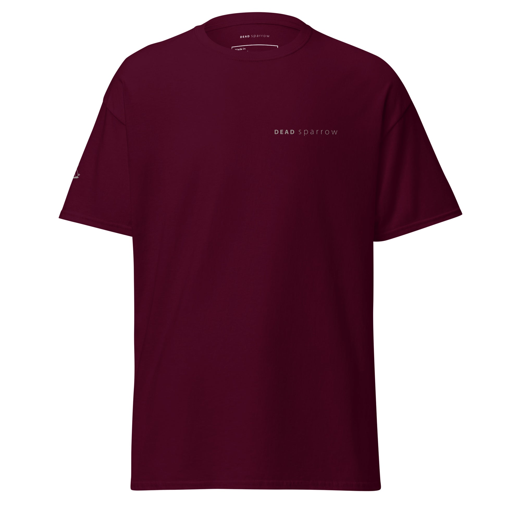 Image of a maroon t-shirt, item name Hopeful. It has print both on the right sleeve and left side. Sparrow on the right sleeve and the text DEAD sparrow on the left side of the t-shirt.