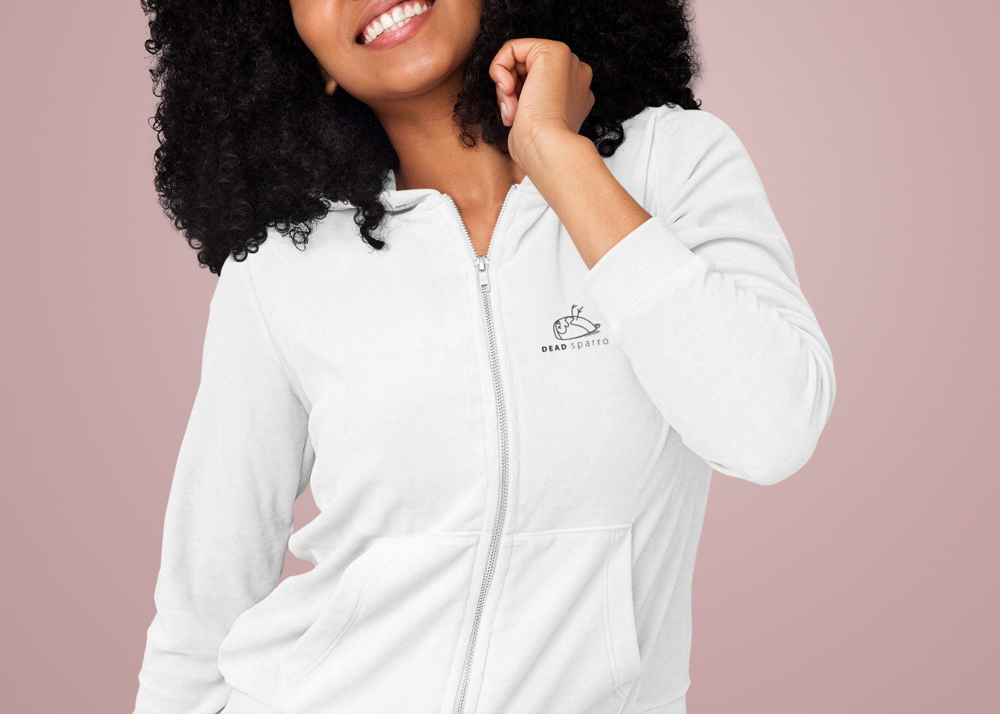 Close-up of a woman wearing a white zip-up hoodie, product name Fabulous. print on the left side, logo "DEAD sparrow" and of a sparrow