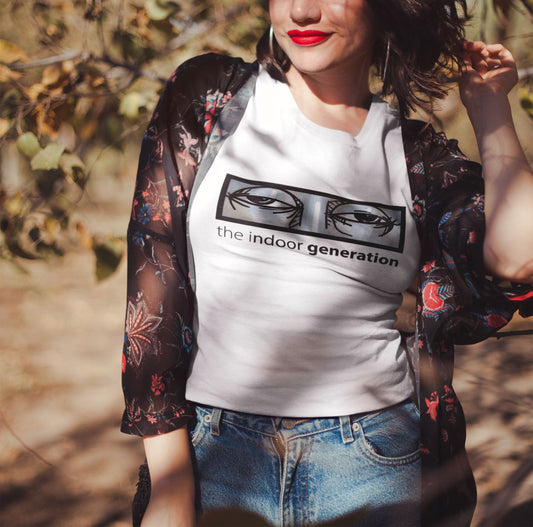 Image of a woman wearing a white T-shirt, product name; Special. Woman standing under a tree looking at the sun.